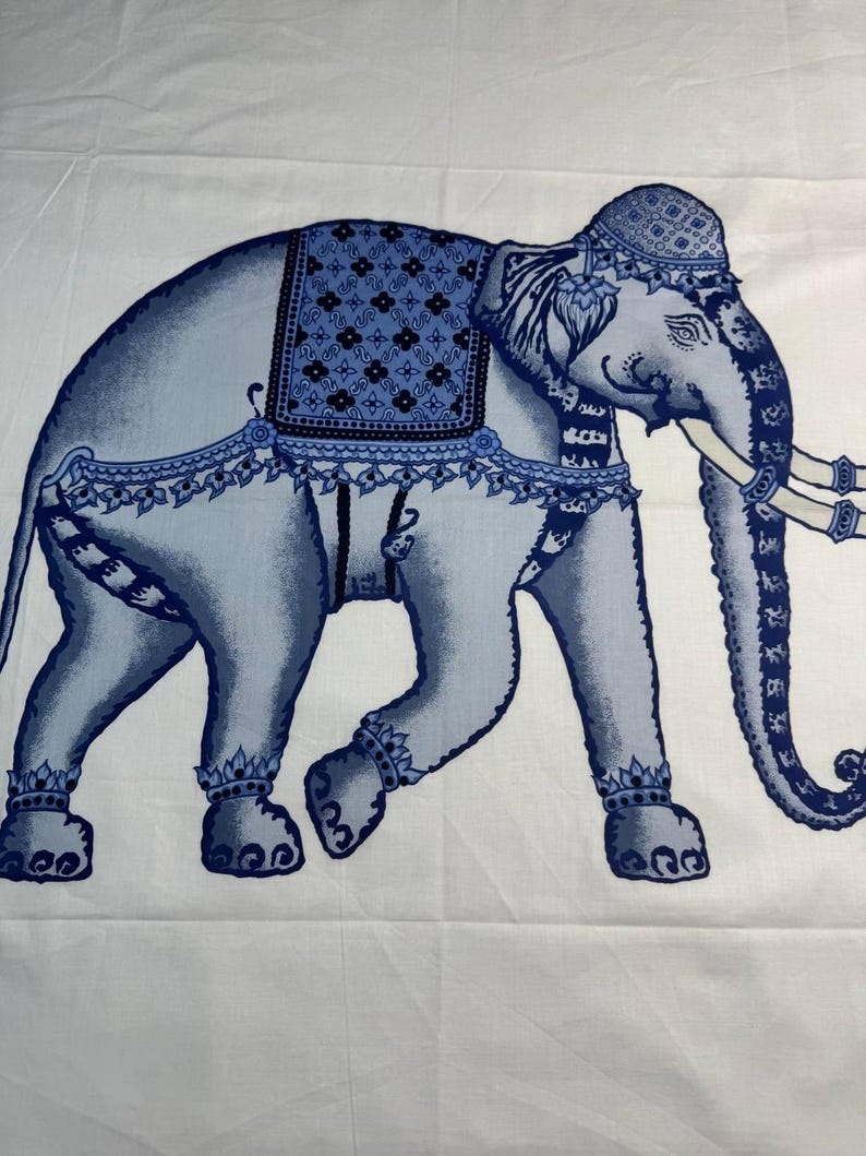 May include: A blue and white elephant design on a white background. The elephant is decorated with blue patterns on its head, back, and legs. The elephant has white tusks and is walking to the left.