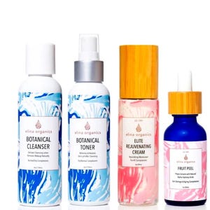 May include: Four Elina Organics skincare products are displayed against a white background. The products include a cleanser, toner, rejuvenating cream, and fruit peel. The bottles have white and blue wave designs, with wooden and white caps. The labels feature the brand name and product details.