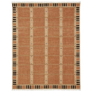 May include: A rectangular woven rug in shades of orange, beige, and brown. The rug has a repeating geometric pattern of vertical lines and rectangular blocks. The edges are finished with a fringe.