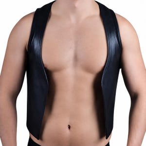 May include: A sleeveless black vest with a smooth, semi-glossy finish. The garment features a deep, open front design with wide shoulder panels and a straight hemline, constructed from a solid black material that reflects light along the edges.