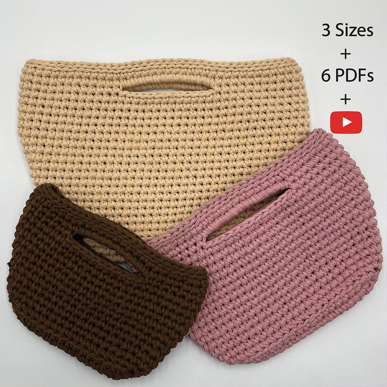 May include: Three crochet handbags in beige, pink, and brown. Each bag has a rectangular shape with a handle and a cutout. The image includes text that reads "3 Sizes + 6 PDFs +" and a YouTube play button icon.