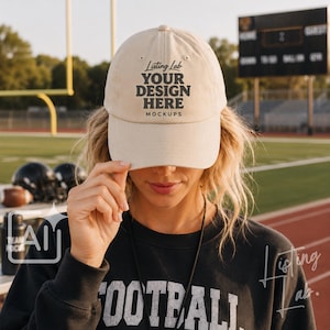 May include: A beige baseball cap featuring the black text Listing Lab YOUR DESIGN HERE MOCKUPS on the front panel. The cap has a structured crown, a curved brim, and embroidered eyelets on the top panels for ventilation and a classic fit.