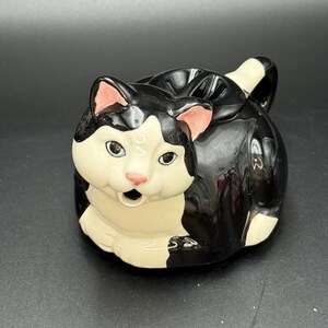 vintage ceramic tea pot  shaped like a black and white tuxedo cat