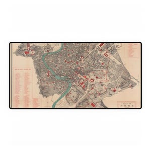 May include: A vintage map of Rome, Italy, with a beige background and red and black lines. The map shows the city's streets, landmarks, and the Tiber River. The text "PLAN OF ROME 1903" is in the bottom right corner.