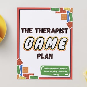May include: A white paper with a red border features the text "THE THERAPIST GAME PLAN" in a playful font. The words "GAME" and "PLAN" are in a yellow and black font. Colorful toy blocks decorate the corners. A yellow teacup and saucer are in the upper left.