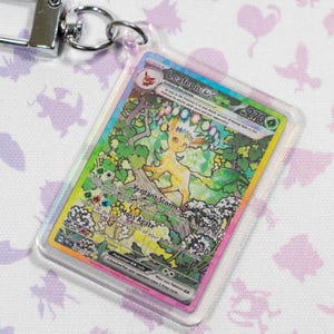 Llavero holográfico acrílico de carta Leafeon ex 144 Prismatic Evolution Pokémon TCG en miniatura