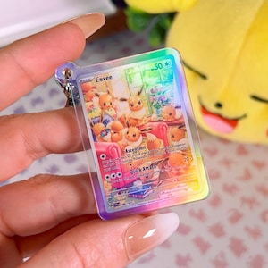 Llavero holográfico acrílico de carta Eevee Twilight Masquerade Pokémon TCG en miniatura
