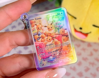 Miniature acrylic holographic keychain of a Twilight Masquerade Pokémon TCG card, Eevee card