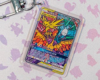 Holographic acrylic keychain of Moltres, Zapdos and Aticuno GX card SM210 Promo Pokémon TCG miniature