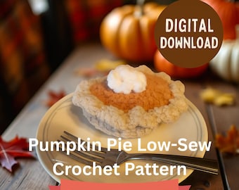 May include: A crocheted pumpkin pie on a white plate with a fork. The pie has an orange filling and a white whipped cream topping. The image includes the text "Pumpkin Pie Low-Sew Crochet Pattern" and "Digital Download".