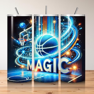 May include: A basketball-themed tumbler with a vibrant design. The tumbler features a basketball, a hoop, and the word "MAGIC" in bold letters. The design incorporates blue, orange, and white colors, with a dark background and a basketball court.