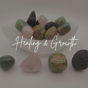 May include: A collection of polished gemstones in various colors, including green, pink, and black, displayed in a white bowl. The text "Healing & Growth" is written in a cursive font across the image. The gemstones are smooth and rounded.
