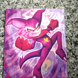 May include: A vibrant artwork featuring a purple character with a yellow eye and a red cape. The character is in a dynamic pose, set against a purple and white background with a smiling face. The artwork is signed.