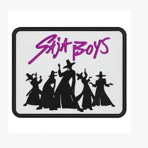 May include: Embroidered patch featuring the text "Saja Boys" in purple script above a silhouette of six figures in hats and long coats. The patch has a white background and a black border.