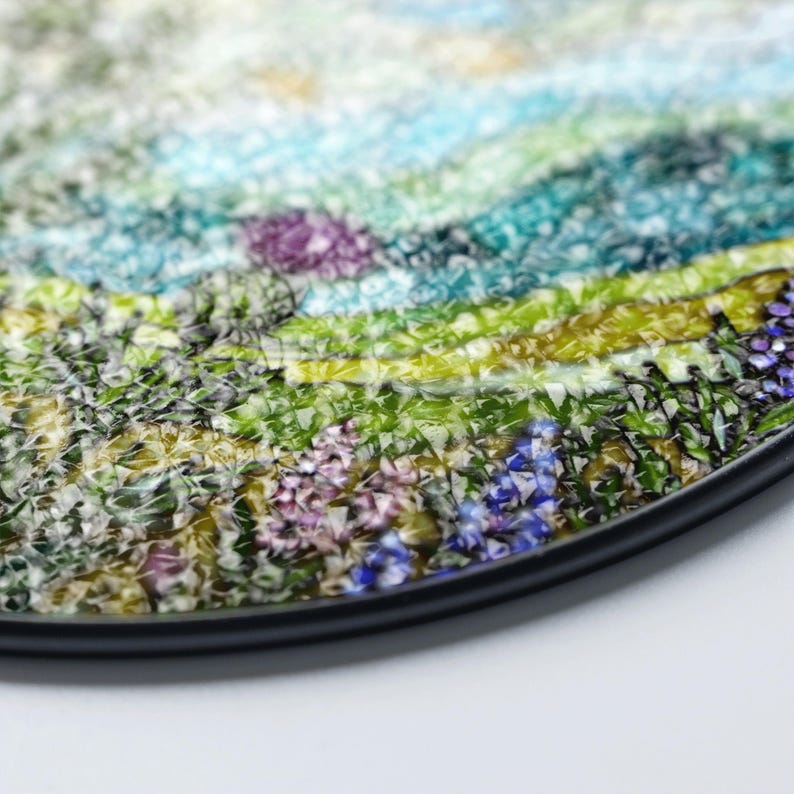 The image is a close-up of a colorful, textured surface with a variety of shapes and patterns, including flowers and leaves.