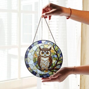 a stained glass owl hanging from a chain