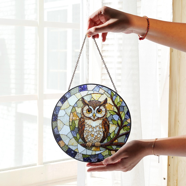 a stained glass owl hanging from a chain