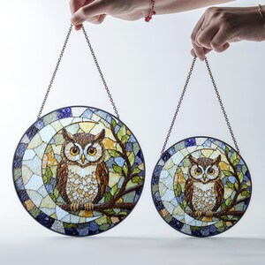a pair of stained glass owls hanging from chains