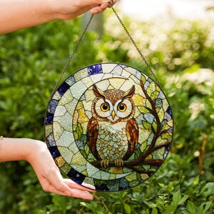 a stained glass owl hanging from a chain