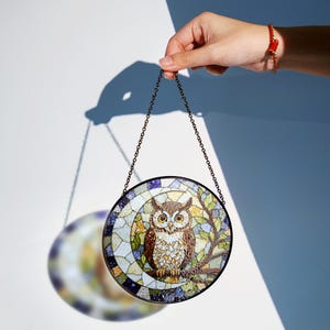 a stained glass owl hanging from a chain