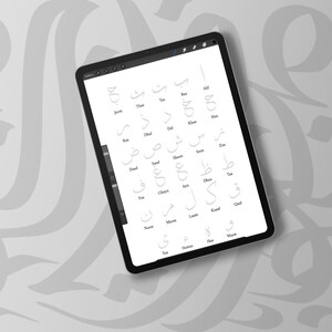 May include: A digital tablet displaying Arabic calligraphy letters in a grid layout. The letters are in a light gray color against a white background. The tablet is black and rests on a light gray surface with a subtle pattern.