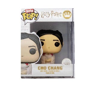 May include: A white and red Bitty Pop! vinyl figure of Cho Chang from the Harry Potter series. The figure is in a clear plastic display case with a white background. The figure is wearing a white dress with a red sash and has black hair.