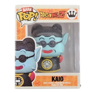 May include: Bitty Pop! vinyl figure of the character Kaio from Dragon Ball Z. The figure is light blue with black glasses, a black outfit, and a red accent. The figure is in a box with the Bitty Pop! and Dragon Ball Z logos.
