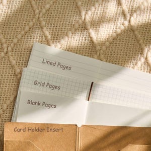 May include: A selection of paper inserts for a card holder, including lined, grid, and blank pages. The text "Lined Pages", "Grid Pages", "Blank Pages", and "Card Holder Insert" are printed on the pages and the card holder.