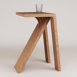 May include: A wooden side table with a unique, angled design. The table has a natural wood finish and a simple, rectangular top.