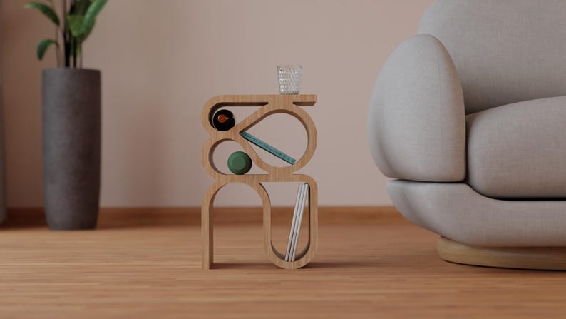 May include: A wooden side table with a unique, abstract design. The table has multiple shelves and curves, and is made of light brown wood. It is decorated with a green ball, a blue book, and a clear glass.