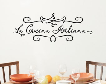 Könnte beinhalten: Ein Esstisch, der für eine Mahlzeit gedeckt ist, mit terrakottafarbenen Tellern, klaren Weingläsern und frischem Obst. An der Wand über dem Tisch steht der Text "La Cucina Italiana" in eleganter Schrift, umrahmt von dekorativen Verzierungen.