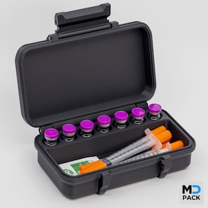 May include: A white ceramic mug with a black handle and the text "But First, Coffee" in a black, bold font. The mug is on a white surface.