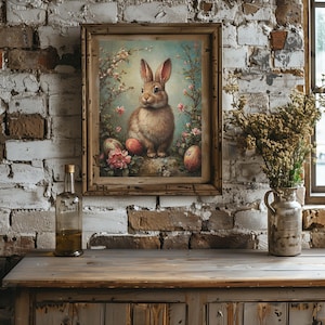 May include: A framed vintage illustration of a brown rabbit sitting on a rock surrounded by pink flowers and colorful Easter eggs.