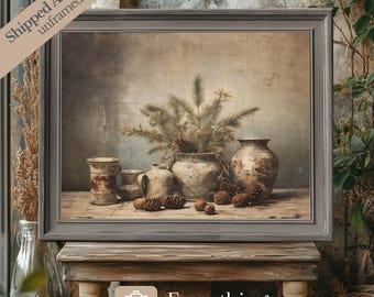May include: A framed print of a still life featuring a vase with pine branches and pine cones, along with other pottery pieces. The background is a textured, beige wall.