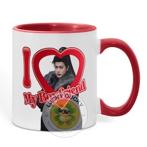 May include: White ceramic mug with a red interior and handle. The mug features the text "I My Boyfriend" in a heart-shaped design, with a photo of a person inside the heart. A small logo is also visible.
