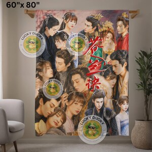 May include: A rectangular throw blanket measuring 60 inches by 80 inches, featuring a vibrant, multi-character collage of figures in traditional East Asian attire, with red Chinese calligraphy characters overlaid in the center and Lucky Ducky logos.