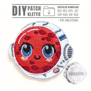 May include: Embroidered patch of a red planet with a smiling face, large blue eyes, and a white space helmet. The patch includes the text "DIY PATCH KLETTIE" and "DIGITALER DOWNLOAD". A smaller patch with the text "RÜCKSEITE" is also visible.