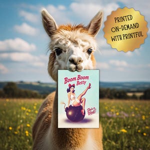 May include: An alpaca holds a card with a vintage pin-up girl illustration. The card reads "Boom Boom Betty" with the tagline "She's a Blast!" A gold seal in the upper right corner says "Printed On-Demand With Printful."
