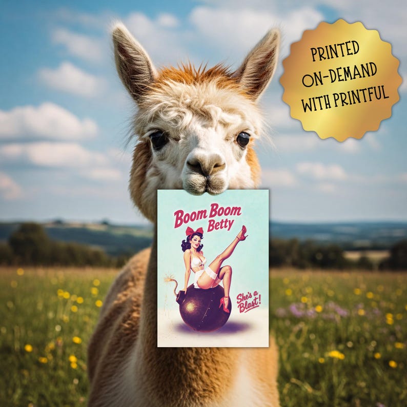 May include: An alpaca holds a card with a vintage pin-up girl illustration. The card reads "Boom Boom Betty" with the tagline "She's a Blast!" A gold seal in the upper right corner says "Printed On-Demand With Printful."