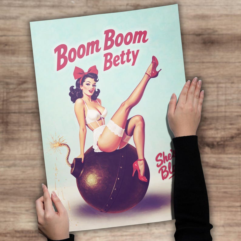 May include: A vintage-style poster featuring a pin-up girl sitting on a bomb. The poster has the text "Boom Boom Betty" in pink, with the girl wearing white lingerie and red heels. The background is a light blue.
