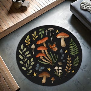 May include: A circular black rug with a whimsical design of mushrooms, butterflies, and foliage in shades of orange, brown, green, and yellow. The rug has a diameter of approximately 122 cm.