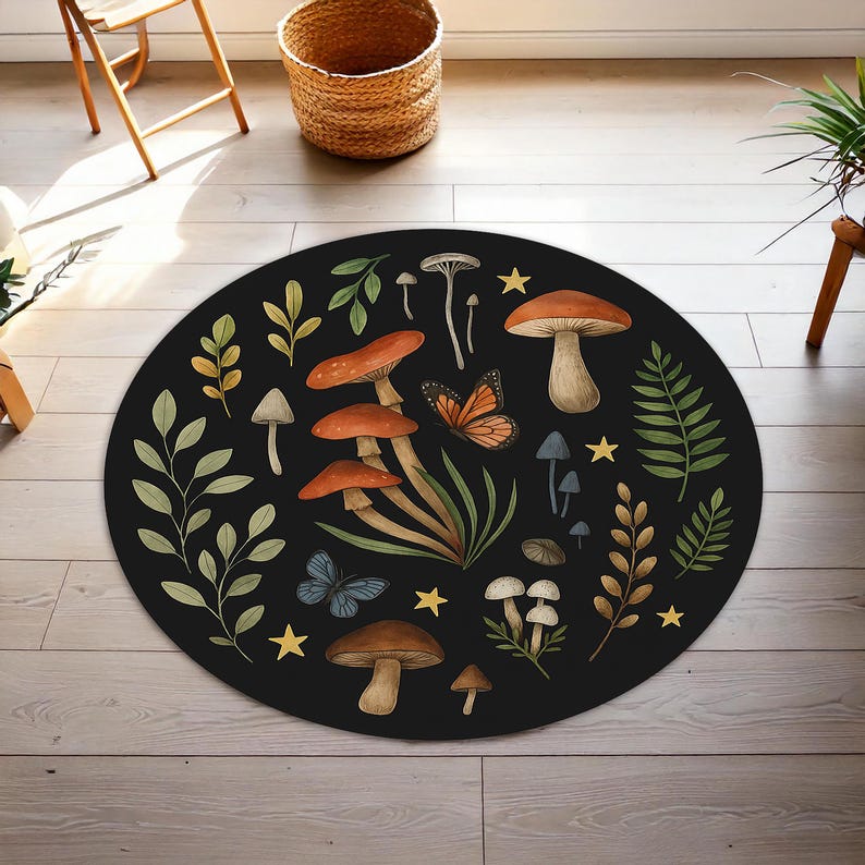 May include: A circular black rug with a mushroom and butterfly pattern. The rug features illustrations of various mushrooms in brown and orange, along with butterflies, stars, and leaves. A decorative floor covering.