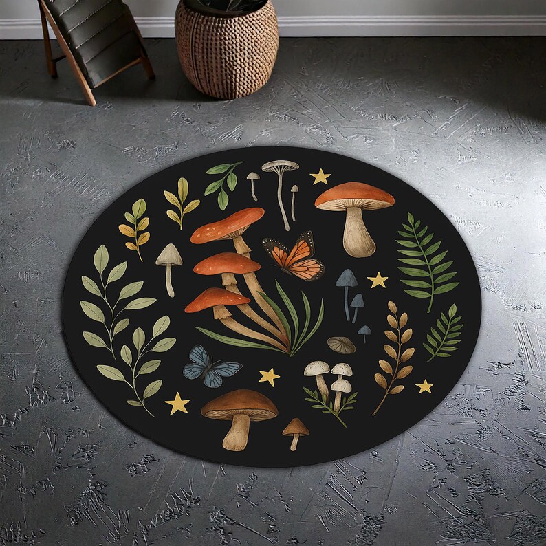May include: A circular black rug with a whimsical mushroom and butterfly design. The rug features illustrations of mushrooms in brown, orange, and white, alongside green foliage, butterflies, and yellow stars. The rug's diameter is approximately 120 cm.