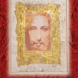 May include: A framed image of a man's face with a beard, the image is printed on a textured paper and framed with a gold leaf frame.
