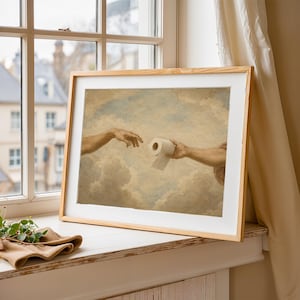 A framed painting depicting two hands reaching towards each other, with one hand holding a roll of toilet paper, set against a cloudy sky background.