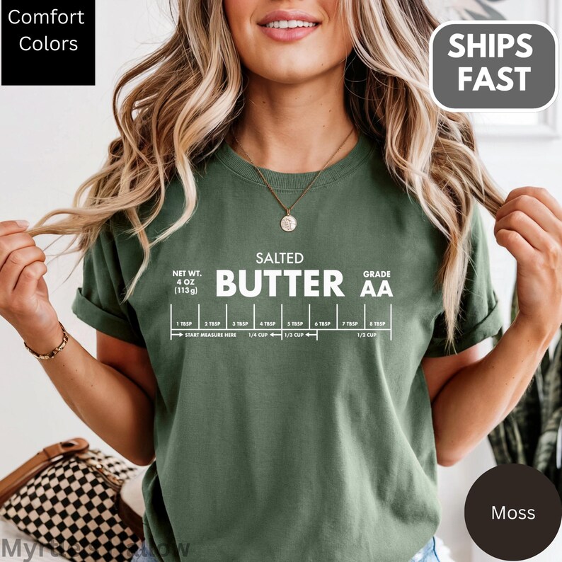 A woman wearing a green t-shirt with a humorous text and a graphic design related to butter.