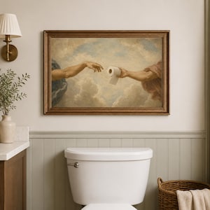 a bathroom with a framed painting of two hands reaching towards a roll of toilet paper hanging above a white toilet.
