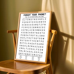 a wooden chair with a large poster or sign on it. The poster contains a list of words and phrases, and it appears to be a challenge or puzzle related to the words and phrases. The poster is placed on a wooden chair, and there is a shadow cast on the wall behind it.