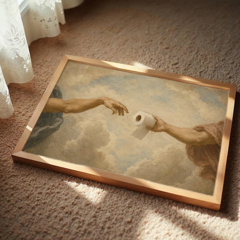 The image is a framed painting depicting two hands reaching towards each other, with one hand holding a roll of toilet paper.