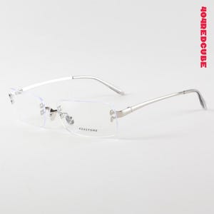 May include: Rimless eyeglasses with a silver metal frame. The rectangular lenses are clear, and the temples are thin and curved. The text "404STORE" is printed on the lower right lens. The text "404REDCUBE" is printed vertically on the right side.
